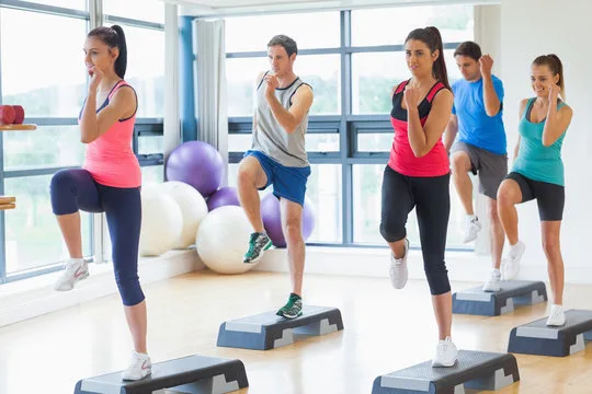 A group of fitness enthusiasts performing Aerobics
